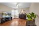 The living room boasts gleaming hardwood floors, a ceiling fan, and lots of light at 108 Greenwood Ave, Belmont, NC 28012