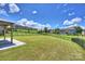 Backyard featuring a covered patio, black fencing, and a lush green lawn for outdoor activities at 11101 Crane Creek Dr, Charlotte, NC 28278