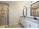 Bright bathroom with double vanity, framed mirrors and a glass enclosed walk-in shower at 11101 Crane Creek Dr, Charlotte, NC 28278