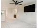 Spacious bedroom featuring neutral walls, carpet, and a ceiling fan. Also has a bathroom ensuite at 11101 Crane Creek Dr, Charlotte, NC 28278