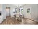 Dining area with wood table, four chairs, access to the backyard, and shiplap accent wall at 11101 Crane Creek Dr, Charlotte, NC 28278