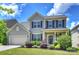 Charming two-story home featuring well-manicured lawn, attached garage and beautiful landscaping at 11101 Crane Creek Dr, Charlotte, NC 28278