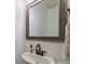 Stylish half bath with a framed mirror, black faucet, white sink, and modern fixtures at 11101 Crane Creek Dr, Charlotte, NC 28278