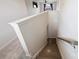 Hallway with stairs leading down, wood railing, neutral paint, and carpet on landing at 11101 Crane Creek Dr, Charlotte, NC 28278