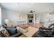Spacious living room with stone fireplace, ceiling fan and stylish furniture at 11101 Crane Creek Dr, Charlotte, NC 28278