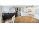 Open concept living room with a stone fireplace, gray couch and a view to the kitchen at 11101 Crane Creek Dr, Charlotte, NC 28278