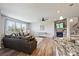 Bright living room with a stone fireplace, hardwood floors, and ample natural light at 11101 Crane Creek Dr, Charlotte, NC 28278