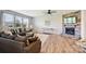 Bright living room featuring a stone fireplace, hardwood floors, and comfortable seating at 11101 Crane Creek Dr, Charlotte, NC 28278