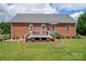Large backyard featuring a multi-level deck, brick facade and manicured landscaping at 1111 Lizzie Ln, Salisbury, NC 28147