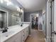 Bathroom with dual sinks, a large mirror, a shower, and a view to a walk-in closet at 1111 Lizzie Ln, Salisbury, NC 28147