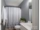 Well-lit bathroom with white vanity, patterned shower curtain, and neutral walls at 1111 Lizzie Ln, Salisbury, NC 28147
