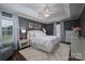 Primary bedroom with tray ceiling, neutral tones, a ceiling fan, and a decorative rug at 1111 Lizzie Ln, Salisbury, NC 28147