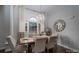 Sunlit dining area with a rustic table, chandelier, and neutral tones for a cozy atmosphere at 1111 Lizzie Ln, Salisbury, NC 28147
