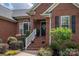 Close-up of the front entrance with brick steps and decorative plantings, creating curb appeal at 1111 Lizzie Ln, Salisbury, NC 28147
