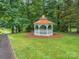 A gazebo is centered on a grassy area with a paved walking path next to it at 1111 Lizzie Ln, Salisbury, NC 28147