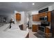 Kitchen features stainless steel appliances, light countertops, and a view into the living room at 1111 Lizzie Ln, Salisbury, NC 28147