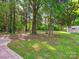 Expansive backyard featuring mature trees, a patio area, and outdoor seating at 11718 Battery Pl, Charlotte, NC 28273