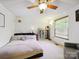 Bright bedroom with a ceiling fan, large window, and neutral decor at 11718 Battery Pl, Charlotte, NC 28273