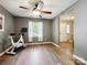 Neutral bedroom featuring wood floors, a ceiling fan, and a view to an adjacent room at 11718 Battery Pl, Charlotte, NC 28273