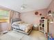 Charming pink bedroom with ample natural light, ceiling fan, and cozy decor at 11718 Battery Pl, Charlotte, NC 28273