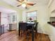 Quaint breakfast nook featuring a black table with chairs, bright natural light, and hardwood floors at 11718 Battery Pl, Charlotte, NC 28273
