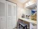 This primary suite dressing area features bright vanity lighting, marble countertop and mirrored wall at 11718 Battery Pl, Charlotte, NC 28273