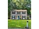 Charming two-story home featuring a blue front door and well-maintained lawn and traditional black shutters at 11718 Battery Pl, Charlotte, NC 28273
