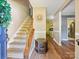 Spacious hallway with hardwood floors, leading to the staircase and other areas of the home at 11718 Battery Pl, Charlotte, NC 28273
