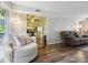 Open-concept living room featuring hardwood floors, comfortable seating, and seamless flow into the adjacent kitchen area at 11718 Battery Pl, Charlotte, NC 28273