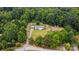 Aerial view of wooded property with home and sheds at 12382 Ritchie Rd, Midland, NC 28107