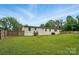 Large grassy yard and house exterior with privacy fence at 12382 Ritchie Rd, Midland, NC 28107