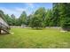 Large backyard, surrounded by privacy fence and mature trees at 12382 Ritchie Rd, Midland, NC 28107