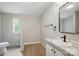 Bathroom featuring a single vanity with granite counters, and a toilet in its own room for privacy at 12382 Ritchie Rd, Midland, NC 28107