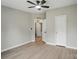 Bedroom with closet, ceiling fan and a view into the bathroom with neutral walls and light filled space at 12382 Ritchie Rd, Midland, NC 28107
