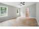 Bedroom boasting great natural light with ceiling fan, multiple windows, and an open entry to bathroom at 12382 Ritchie Rd, Midland, NC 28107
