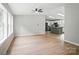 Open-concept living area flowing into a kitchen with modern island and appliances, great for entertaining at 12382 Ritchie Rd, Midland, NC 28107