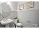 Charming powder room featuring beadboard wall paneling and a stylish pedestal sink at 13102 Indigo Run Ct, Charlotte, NC 28278
