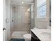 Modern bathroom with a glass-enclosed shower featuring gray herringbone tile and a rainfall shower head at 13102 Indigo Run Ct, Charlotte, NC 28278
