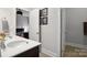 Charming bathroom featuring a modern vanity, stylish decor, and an open doorway to an adjacent bedroom at 13102 Indigo Run Ct, Charlotte, NC 28278