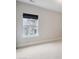 Empty bedroom with neutral carpet, large window, and white trim at 13102 Indigo Run Ct, Charlotte, NC 28278