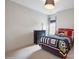 Well-lit bedroom featuring a playful sports-themed decor and a view of the outdoors at 13102 Indigo Run Ct, Charlotte, NC 28278