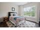 Bright bedroom with a large window providing ample natural light and views of the outdoors at 13102 Indigo Run Ct, Charlotte, NC 28278