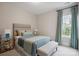 Comfortable bedroom with stylish decor, including teal accents, a patterned bedspread, and soft lighting at 13102 Indigo Run Ct, Charlotte, NC 28278