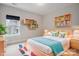 Bright bedroom with wooden bedframe, built-in shelving, colorful decor, and large window at 13102 Indigo Run Ct, Charlotte, NC 28278