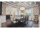 Formal dining room featuring stylish wallpaper, coffered ceiling, and elegant lighting at 13102 Indigo Run Ct, Charlotte, NC 28278