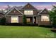Charming brick home featuring a well-manicured lawn, and manicured landscaping at 13102 Indigo Run Ct, Charlotte, NC 28278