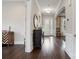 Elegant hallway featuring dark wood floors, neutral walls, and decorative lighting at 13102 Indigo Run Ct, Charlotte, NC 28278