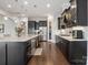 Modern kitchen with dark cabinets, stainless steel appliances, and hardwood floors at 13102 Indigo Run Ct, Charlotte, NC 28278
