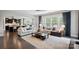 Inviting living room with a ceiling fan, neutral decor, and large windows at 13102 Indigo Run Ct, Charlotte, NC 28278