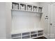 Well-organized mudroom with bench seating, cubbies, and overhead storage at 13102 Indigo Run Ct, Charlotte, NC 28278
